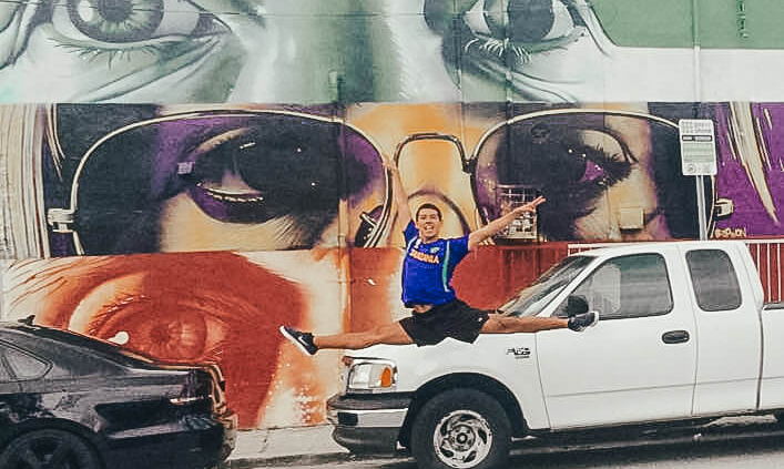 Cars parked on a wall with art