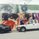 Cars parked on a wall with art